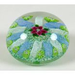 A Paul Ysart style paperweight, the mottled green ground decorated with a central pink flower with