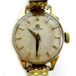 An Omega 9ct gold cased lady's wristwatch, circular silvered dial with gold batons and gold hands,