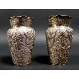A pair of Chinese white metal vases, of balluster form, with scallop edged rims, the body chased