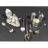 A collection of Eastern white metal cruet sets and spoons, including one set comprising salt cellar,