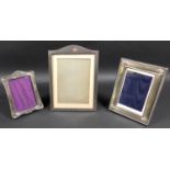 A group of three silver picture frames, comprising a frame with engine turned decoration, Mappin and