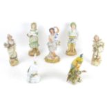 A group of seven continental porcelain and bisque figurines, comprising two porcelain cockatoos,