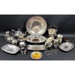 A large collection of silver plated wares including a strawberry plate, an ice bucket and tongs,