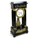 A French Empire ebonised portico clock, circa 1870, the fluted columns with brass stringing and gilt