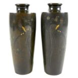 A mirrored pair of Japanese Meiji period bronze vases, of shouldered tapering cylindrical form,