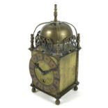 A brass cased lantern clock, in the 17th century style, with strapwork bell top within pierced