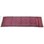 A red ground Meshwani runner, with flat weave ends, 224 by 57cm.