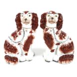 A pair of Victorian Staffordshire flatback fireside dogs, modelled as spaniels, each 25cm high. (2)