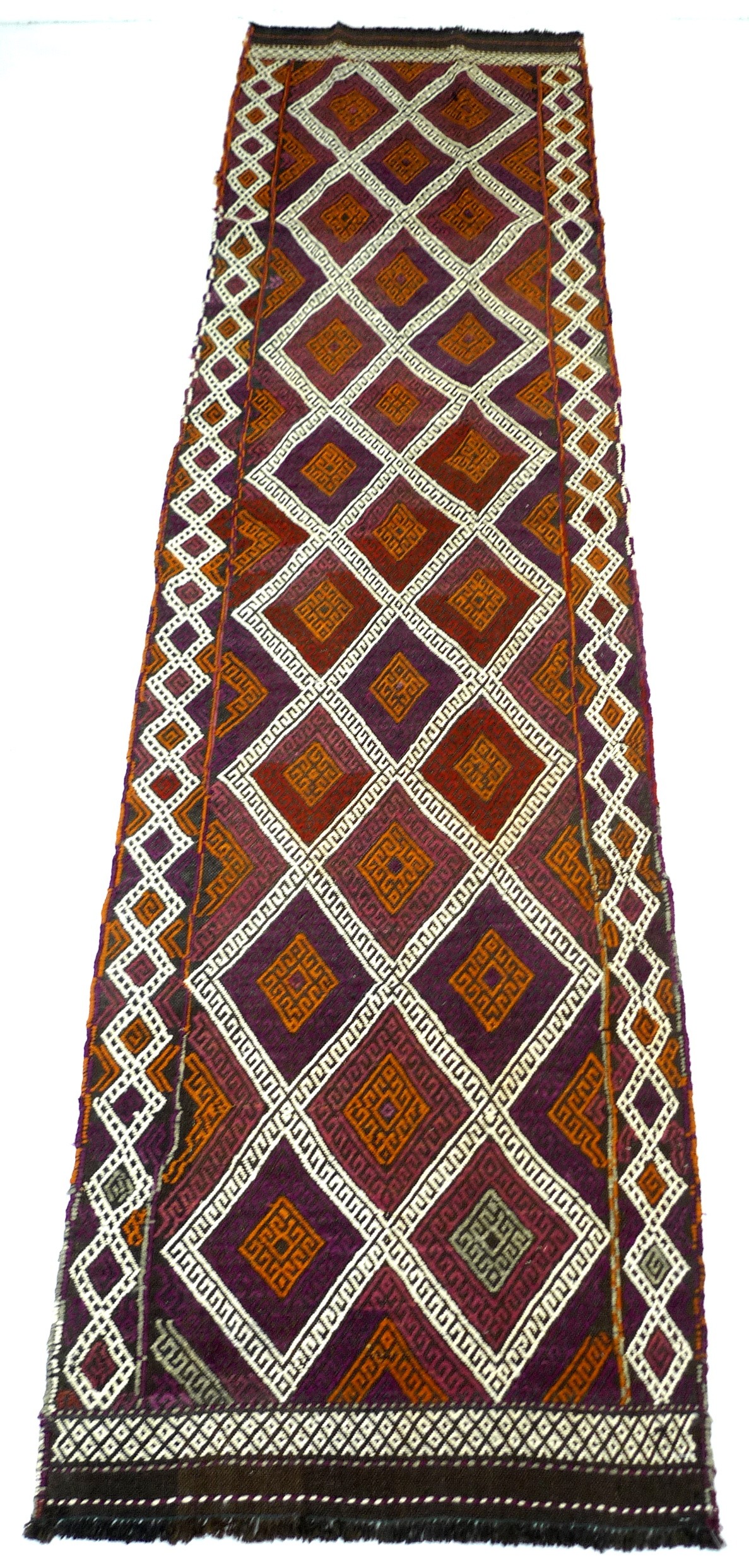 An old Suzni kelim runner, decorated with zoomorphic and foliate designs upon a red ground 295 by