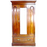 A Victorian mahogany wardrobe, with single bevelled mirror door enclosing a hanging space, and