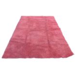 A large contemporary 'Opus Shaggy' rug, with crimson ground, 245 by 345cm.