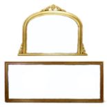 A modern Victorian style overmantle mirror, with gold coloured frame and bevelled arched plate,