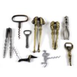 A collection of 19th century and later cork screws and nut crackers, including one Victorian