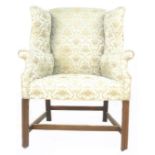 A Georgian style wing armchair, pale green and gold velour, 74 by 82 by 110cm high.
