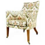 An early Victorian armchair, with deep seat and squared tub shaped back, upholstered in floral