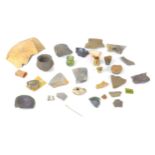 A collection of archaeological items, including a Roman white metal pin, found in Rodbridge, Long