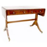 A Regency mahogany sofa table, reeded edges, drop flaps, two frieze drawers, raised on outswept legs