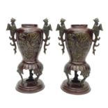 A pair of decorative 20th century bronze vases, decorated with birds in prunus blossom and pheonix