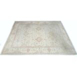 A modern Persian carpet with cream ground, pale floral multi coloured decoration, wide scrolling