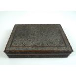 An Edwardian carved wooden box, decorated throughout with scrolling foliage and arabesques, with