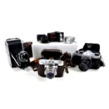 A collection of vintage cameras and accessories, including a Voigtlander Vito B, with case, an