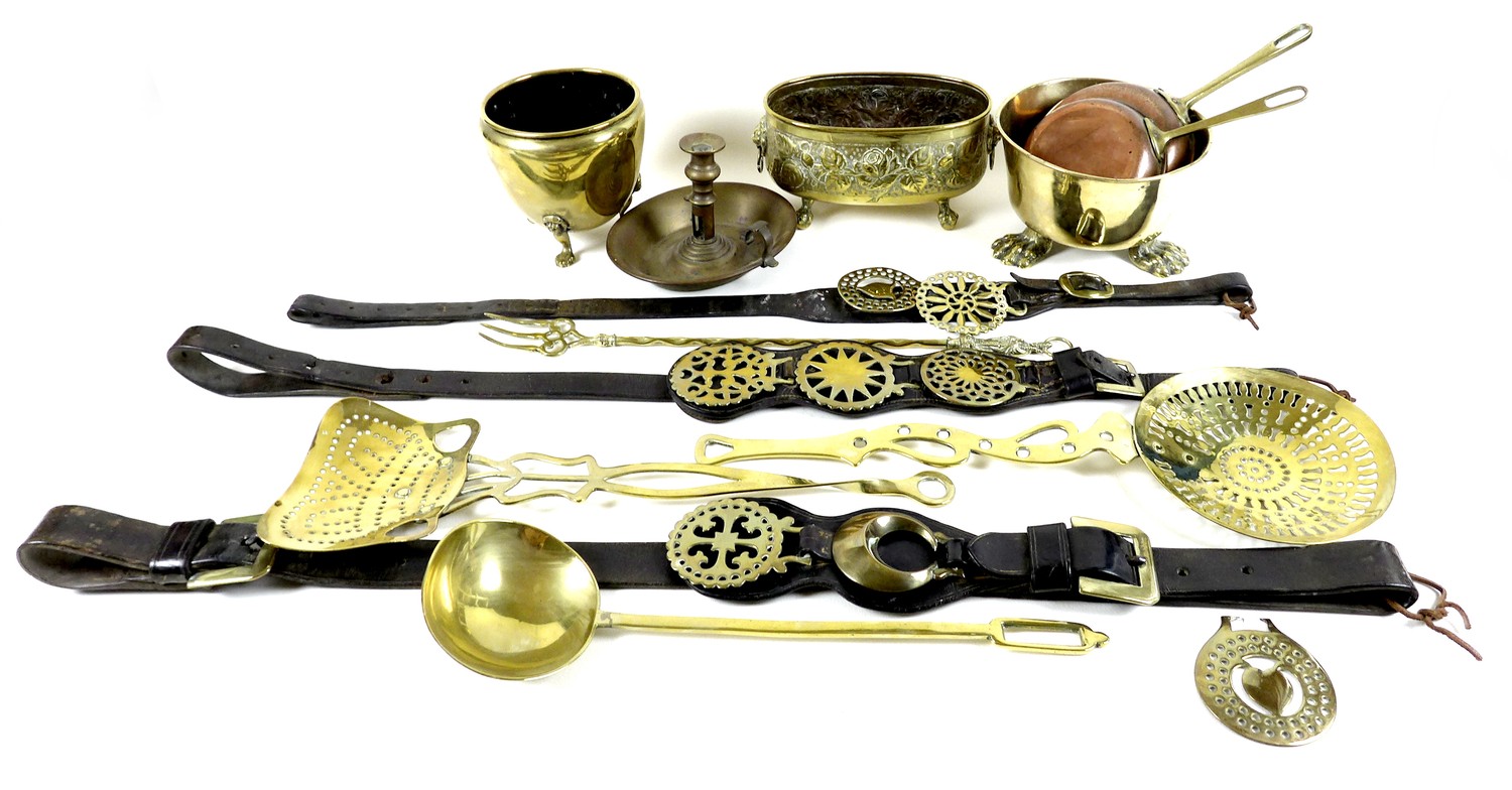 A collection of copper and brass wares, comprising two small copper skillets, 17 by 32 by 4cm high