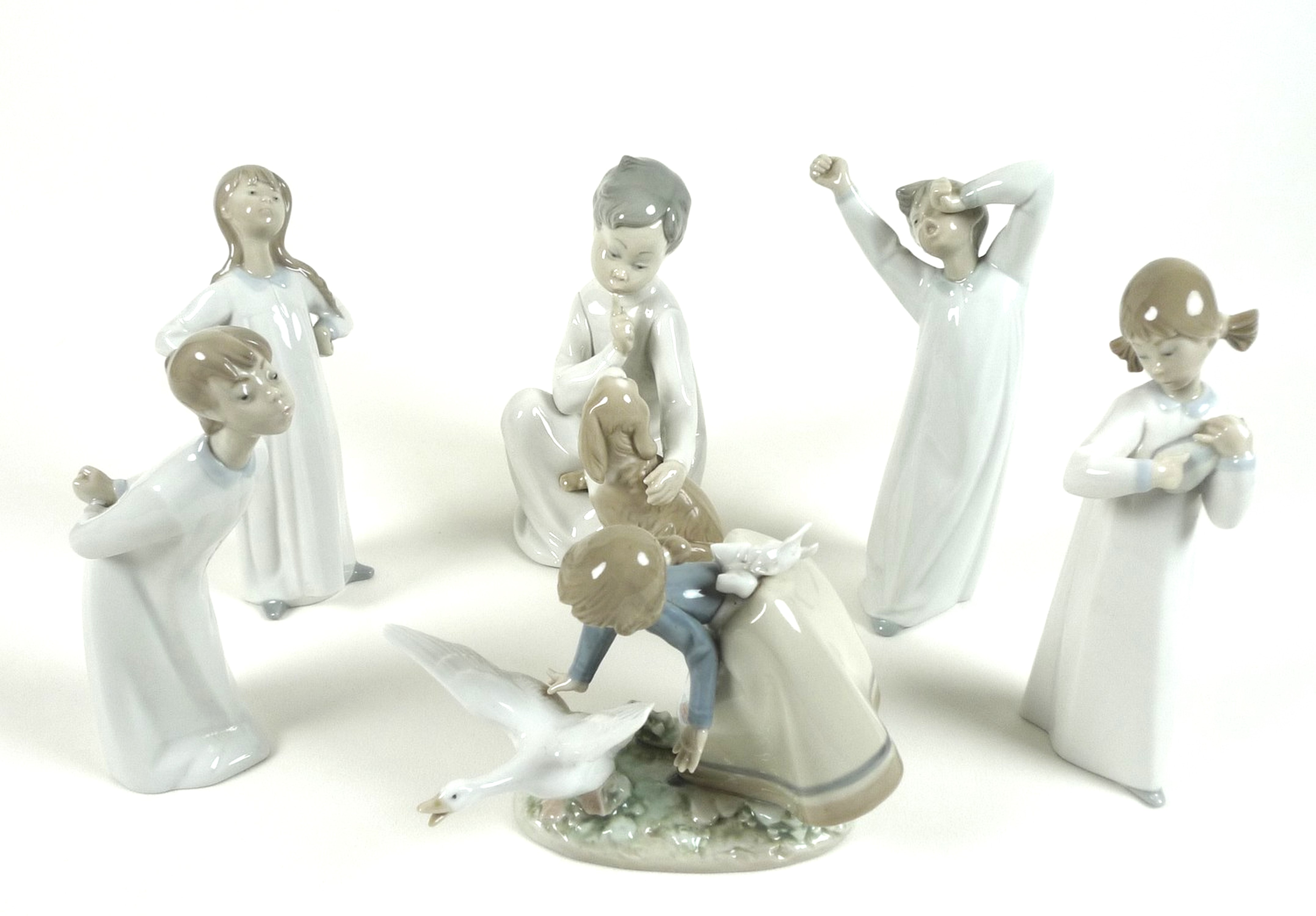 A group of six Lladro figures, comprising Wild Goose Chase, number 5553, 15cm high, Nino con