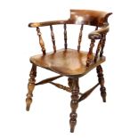 A Victorian oak smoker?s bow armchair, turned supports and shaped seat, with pale green buttoned