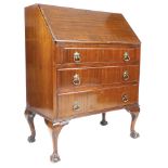 A reproduction mahogany bureau, with fall front, to fitted interior, above three drawers, raised