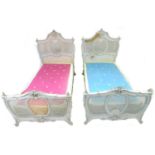 A pair of early 20th century cream painted single bed frames, in French Rococo style, with caned