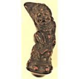 An Indonesian carved wooden kris handle formed as Rangha. 11.5 cm high. Late 20th c. Notes: The