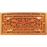 Carved hardwood panel from Bali showing two birds. These are placed at the top of an outside wall to