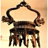 A very special temple lamp from Nepal with dragons supporting the oil dish. Lamps like this are