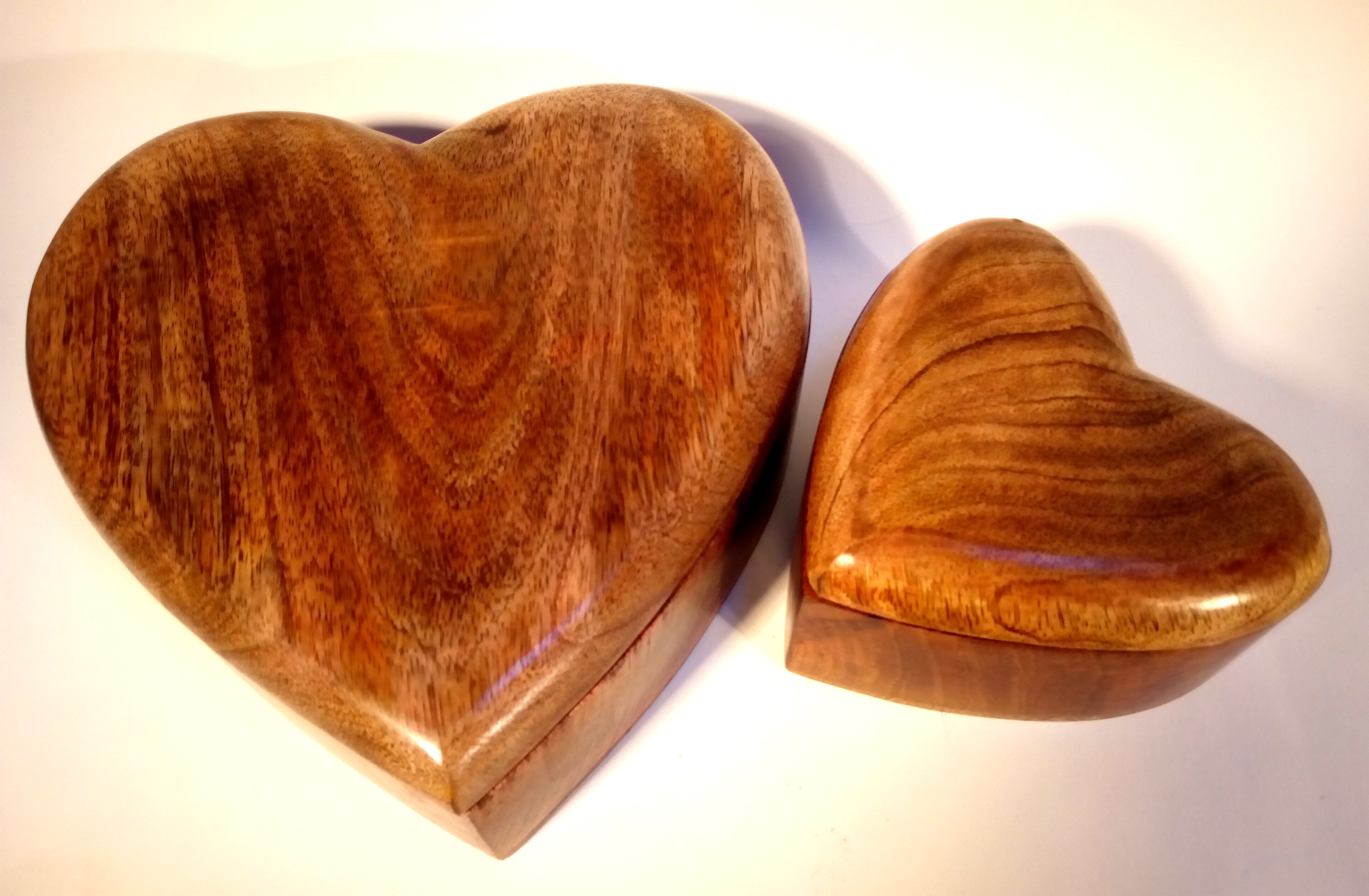 Two heart shaped boxes with lids. Carved in Mango wood from India. Mango wood is a prolific and