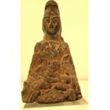 A figure carved from a very hard silcate stone with specks of mica. There are very obvious designs