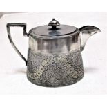 Tea Pot in beautiful shining metal. It is finely engraved with tiny flowers that have been gold