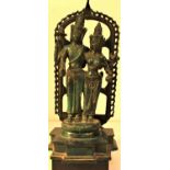 Cast metal statue of lord Vishnu and Parvati standing on a lotus leaf and framed by a decorated