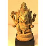 Bronze Ganesh from Bali. Ganesh, the elephant god is drinking from a honey pot, in one hand he holds