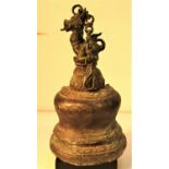 A heavy temple bell cast in bronze in Bali. The bell is crowned with a mythical beast. 28 x 14cm.