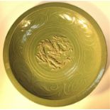 Ceramic bowl in green glaze with Chinese dragon design. Imported to Sumatra from China for Dutch