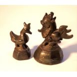 Two Burmese cast bronze opium weights. Largest 5cm high. Mid 20th c. Notes: The heavier one is a
