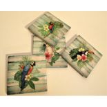 Set of 4 ceramic coasters with exotic bird and flower designs. 4 rubber cushion pads on bottom.