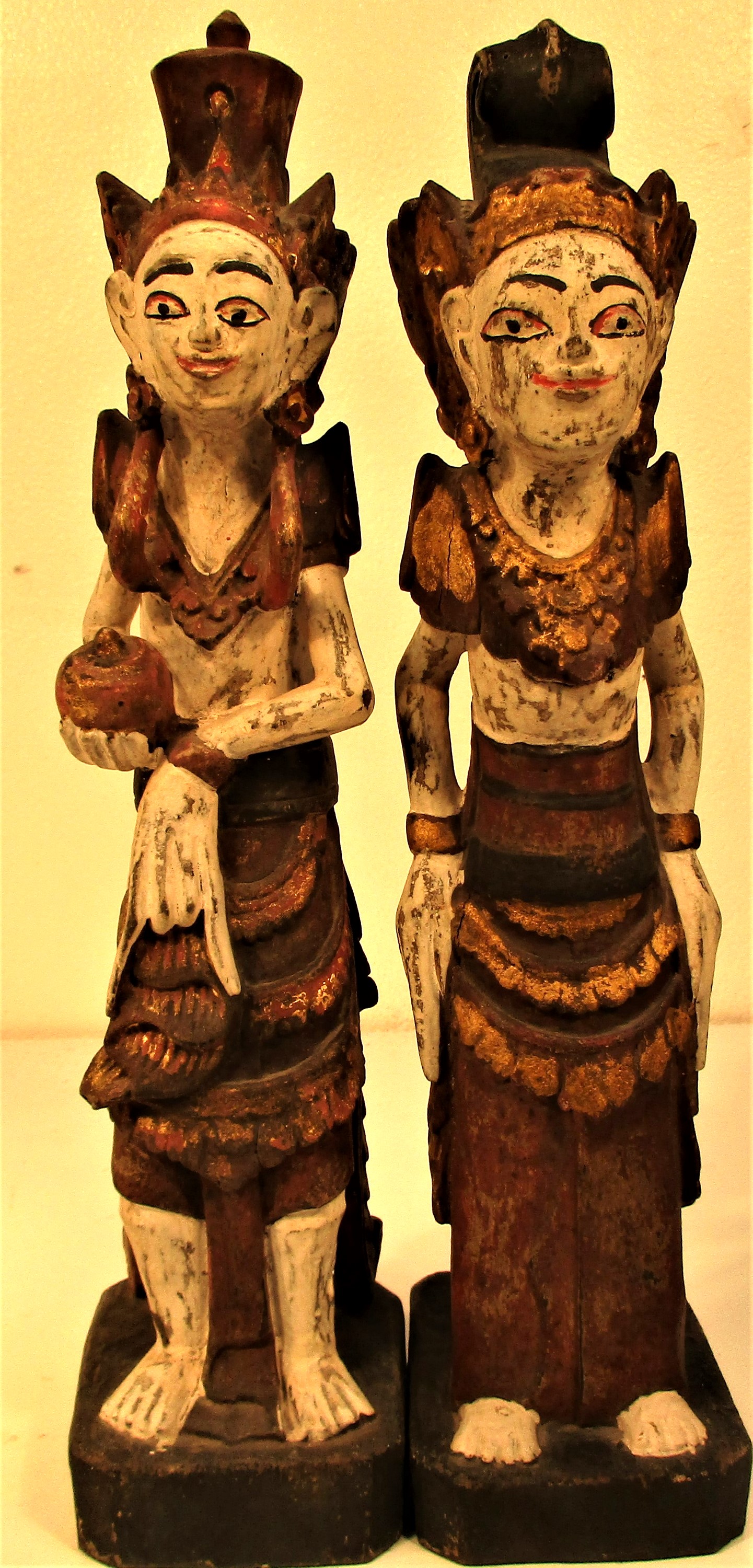 Wedding couple statues from east Bali. They are carved wearing tradition costumes and head dress,