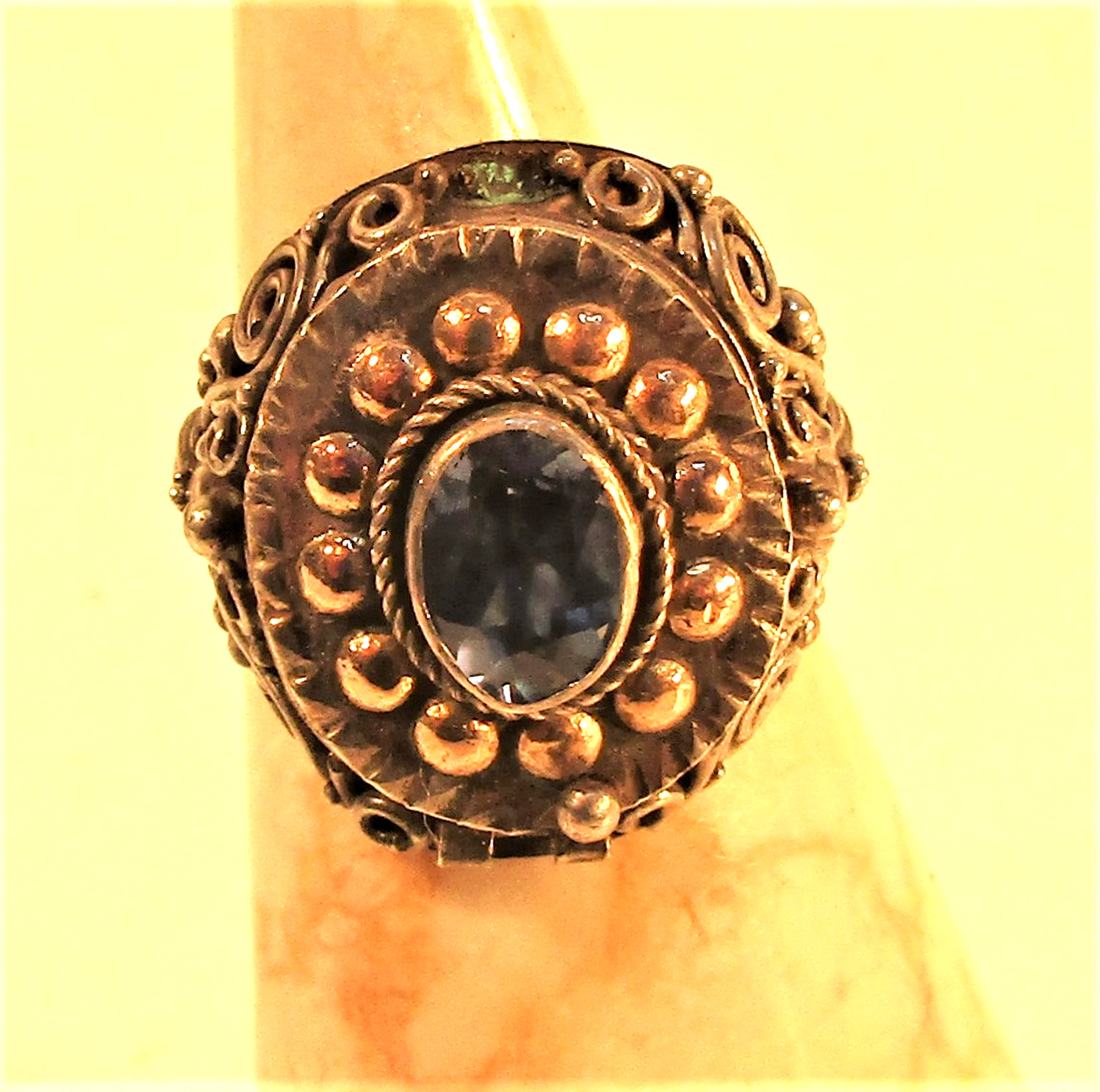 Metal with gold wash and glass stone ring with a secret compartment.