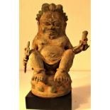 Bronze Chinese Buddha, cast in Bali. Buddha is holding a torje and a horn. 25 x 15cm. Early 21st c.