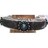 A nomad bracelet, the metal is skilfully etched and is decorated with five turquoise stones. 9cm.