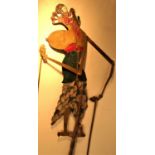 Wayan kulit, shadow puppet from Bali. The silver paint on the face is to shine when lit by an oil
