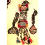 Afghanistan. Mirror, cloves and 2 beaded amulets. This would be hung amongst cloths, textiles and
