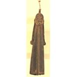 A brass figure of indetermined origins and age, (it could be Coptic). Wearing a full length robe