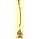 A triangular Afghan pendant with coral beads on chain. 30cm.